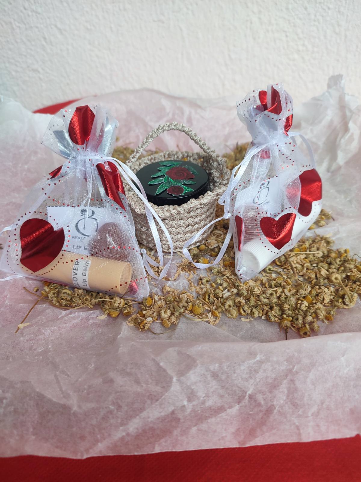 Daily skincare essentials set with moisturizing lip balm and soothing foot balm in a handmade basket.